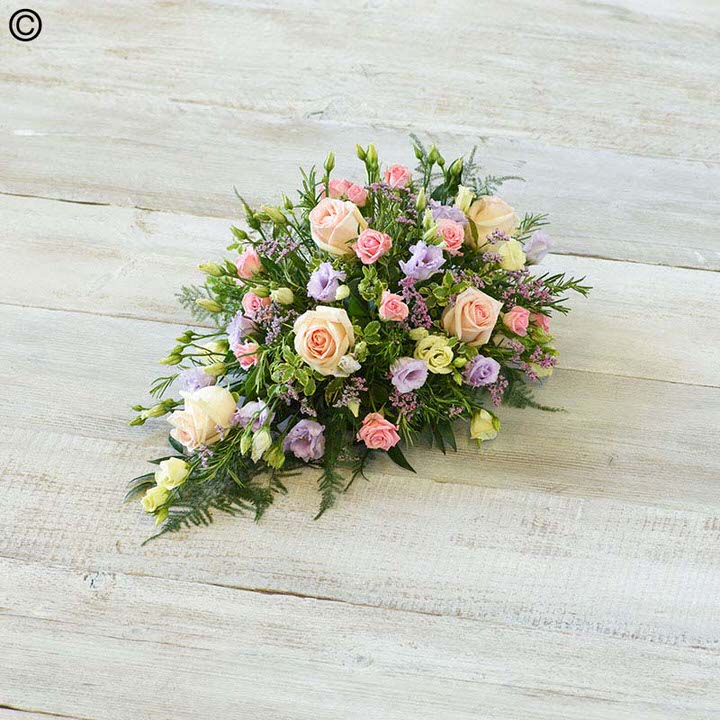 <h2>Pink and White Children's Casket Spray | Funeral Flowers</h2>
<ul>
<li>Approximate Size 70cm x 30cm</li>
<li>Hand created classic pink and white casket spray in fresh flowers</li>
<li>To give you the best we may occasionally need to make substitutes</li>
<li>Funeral Flowers will be delivered at least 2 hours before the funeral</li>
<li>For delivery area coverage see below</li>
</ul>
<br>
<h2>Liverpool Flower Delivery</h2>
<p>We have a wide selection of casket flowers offered for Liverpool Flower Delivery. Casket flowers can be provided for you in Liverpool, Merseyside and we can organize Funeral flower deliveries for you nationwide. Funeral Flowers can be delivered to the Funeral directors or a house address. They can not be delivered to the crematorium or the church.</p>
<br>
<h2>Flower Delivery Coverage</h2>
<p>Our shop delivers funeral flowers to the following Liverpool postcodes L1 L2 L3 L4 L5 L6 L7 L8 L11 L12 L13 L14 L15 L16 L17 L18 L19 L24 L25 L26 L27 L36 L70 If your order is for an area outside of these we can organise delivery for you through our network of florists. We will ask them to make as close as possible to the image but because of the difference in stock and sundry items it may not be exact.</p>
<br>
<h2>Liverpool Funeral Flowers | Casket Flowers</h2>
<p>This children's casket spray has been loving handcrafted by our expert florists. The pink roses and calla lilies in this sweet spray look beautiful arranged with pure white scented freesia, white September flowers, deep pink lisianthus and finished with seasonal foliages.</p>
<br>
<p>Funeral Casket Flowers the main tribute and are sometimes, depending on the family's wishes, the only flower arrangement. They are usually chosen by the immediate family.</p>
<br>
<p>Casket sprays are placed directly on top of the coffin. The sprays are large diamond shape tributes. The flowers are arranged in floral foam, which means the flowers have a water source meaning they look their very best for the day.</p>
<br>
<p>Containing 3 pink roses, 5 pink calla lilies, 4 white freesia, 3 pink lisianthus, 2 white September flower and seasonal mixed foliages.</p>
<br>
<h2>Best Florist in Liverpool</h2>
<p>Trust Award-winning Liverpool Florist, Booker Flowers and Gifts, to deliver funeral flowers fitting for the occasion delivered in Liverpool, Merseyside and beyond. Our funeral flowers are handcrafted by our team of professional fully qualified who not only lovingly hand make our designs but hand-deliver them, ensuring all our customers are delighted with their flowers. Booker Flowers and Gifts your local Liverpool Flower shop.</p>
<br>
<p><em>Janice Crane - 5 Star Review on Google - Funeral Florist Liverpool</em></p>
<br>
<p><em>I recently had to order a floral tribute for my sister in laws funeral and the Booker Flowers team created a beautifully stunning arrangement. Thank you all so much, Janice Crane.</em></p>